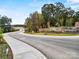 Griffith Lakes entrance with curving road and landscaping at 5220 Mint Harbor Way # 0285, Charlotte, NC 28269