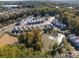 Aerial view of community with pond and homes at 504 Kingsway Cir, Charlotte, NC 28214