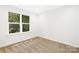 Bright bedroom featuring a large window and neutral carpeting at 1142 Leigh Cir, Charlotte, NC 28216