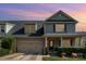 Two-story house with gray siding, two-car garage, and landscaped yard at 131 Aztec Cir, Mooresville, NC 28117