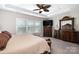 Main bedroom with large window, ceiling fan, and dark wood furniture at 131 Aztec Cir, Mooresville, NC 28117