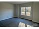 Bright bedroom featuring a large window and carpet at 112 Imperial Way # 2A, Albemarle, NC 28001