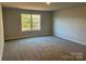 Bright bedroom with carpeted floor and large window at 112 Imperial Way # 2A, Albemarle, NC 28001