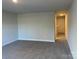 Spacious bedroom with carpeted floor and door at 112 Imperial Way # 2A, Albemarle, NC 28001