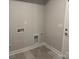 Small laundry room with tile floor and built-in shelving at 112 Imperial Way # 2A, Albemarle, NC 28001