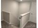 Upstairs hallway with carpeted floor and door at 112 Imperial Way # 2A, Albemarle, NC 28001