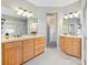 Double vanity bathroom with light-colored cabinets and tiled floor at 3481 Fieldstone Dr, Gastonia, NC 28056