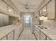 Galley kitchen with white cabinets and tile flooring at 151 Cedar Hollow St, Fort Mill, SC 29715