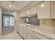 Kitchen with white cabinets and view into living area at 151 Cedar Hollow St, Fort Mill, SC 29715
