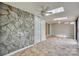 Sunroom with stone wall, tile floors, and multiple ceiling fans at 151 Cedar Hollow St, Fort Mill, SC 29715
