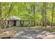 House exterior showcasing a front entrance and driveway, nestled in a wooded setting at 151 Cedar Hollow St, Fort Mill, SC 29715