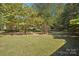Spacious backyard with mature trees and a bird bath at 1026 Holly Dr, Gastonia, NC 28054