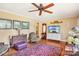 Living room with hardwood floors, comfy seating, and large TV at 1026 Holly Dr, Gastonia, NC 28054