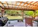 Relaxing patio with seating area and grill, overlooking backyard at 1026 Holly Dr, Gastonia, NC 28054
