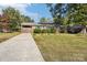 Brick ranch home with a driveway and fenced yard at 1026 Holly Dr, Gastonia, NC 28054