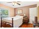 Bright bedroom with double bed, hardwood floors, and a window overlooking the yard at 1026 Holly Dr, Gastonia, NC 28054