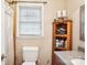 Clean bathroom with toilet, vanity, and linen cabinet at 1026 Holly Dr, Gastonia, NC 28054