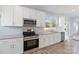Modern kitchen with stainless steel appliances and white cabinets at 1026 Heath Helms Rd, Monroe, NC 28110