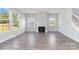 Living room with hardwood floors, fireplace, and large windows at 1026 Heath Helms Rd, Monroe, NC 28110