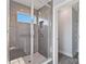 Modern bathroom with grey tile shower, glass enclosure and a window at 1026 Heath Helms Rd, Monroe, NC 28110