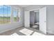 Well-lit bedroom with carpet and access to another room at 1026 Heath Helms Rd, Monroe, NC 28110