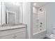 Clean bathroom with white tub, granite vanity, and a spacious mirror at 1026 Heath Helms Rd, Monroe, NC 28110