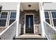 Elegant entryway with stone details and a black front door at 1026 Heath Helms Rd, Monroe, NC 28110