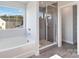 Relaxing bathroom featuring a soaking tub and a grey tile shower at 1026 Heath Helms Rd, Monroe, NC 28110