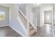 Modern staircase with carpeted steps and white railing at 1026 Heath Helms Rd, Monroe, NC 28110
