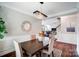 Bright dining room features a wood table, chandelier, and view to the living room at 4423 Falls Lake Sw Dr, Concord, NC 28025