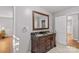 Bathroom with double vanity, dark countertop, and large mirror at 140 Liz Cortland Rd, China Grove, NC 28023