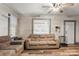 Living room with hardwood floors, neutral-toned sofas, and large windows at 515 Suttle St, Shelby, NC 28150