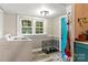 Laundry room with a washer, dryer, and a teal door at 515 Suttle St, Shelby, NC 28150