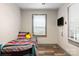 Small bedroom with a twin bed, hardwood floors, and a window with blinds at 515 Suttle St, Shelby, NC 28150