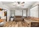 Spacious living room with hardwood floors, neutral sofas, and a marble accent wall at 515 Suttle St, Shelby, NC 28150