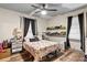 Bedroom with floral bedding, two windows, and ample closet space at 515 Suttle St, Shelby, NC 28150