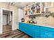 Kitchen with teal cabinets, white countertops, and open shelving at 515 Suttle St, Shelby, NC 28150