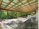 Spacious covered patio, perfect for outdoor entertaining, overlooks a wooded area at 13079 Philadelphia Church Rd, Oakboro, NC 28129