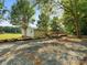 Ranch home with gravel driveway and large deck at 13079 Philadelphia Church Rd, Oakboro, NC 28129