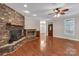 Living room with stone fireplace and hardwood floors at 225 Greenway Ave, Cherryville, NC 28021