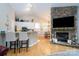 Open concept kitchen with breakfast bar and stone fireplace at 272 Millingport Ln, New London, NC 28127