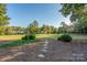 Stone path leads to a large green space and houses at 272 Millingport Ln, New London, NC 28127