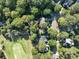 Aerial view of homes nestled in a wooded community near a golf course at 272 Millingport Ln, New London, NC 28127