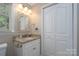 Bathroom with granite countertop, white vanity, and decorative mirror at 272 Millingport Ln, New London, NC 28127