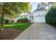 House exterior showcasing a two-car garage and landscaped yard at 272 Millingport Ln, New London, NC 28127