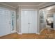 Hallway with hardwood floors, white doors, and a view of another room at 272 Millingport Ln, New London, NC 28127