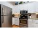 Well-equipped kitchen featuring stainless steel appliances and white cabinets at 272 Millingport Ln, New London, NC 28127