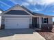 New construction home with gray siding, stone accents, and a two-car garage at 3010 Cunningham Farm Dr, Indian Trail, NC 28079