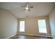 Bedroom with vaulted ceiling, ceiling fan and two windows at 5204 Holbert Cir, Charlotte, NC 28269