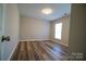 Simple bedroom with a window and wood-look floors at 5204 Holbert Cir, Charlotte, NC 28269